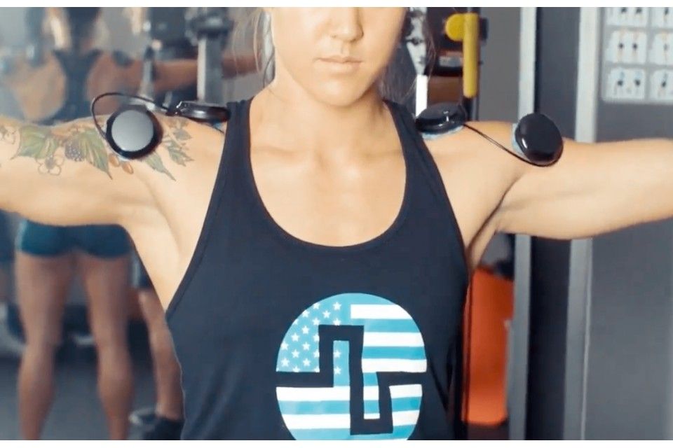 mulher a treinar ombros com compex
